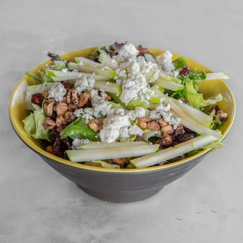 Fresh salad with mixed greens, apples, cheese, walnuts, cranberries.