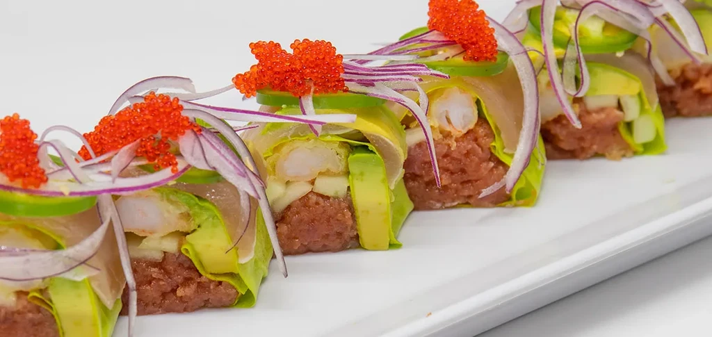 Sushi-style rolls with tuna tartare, avocado, shrimp, red onion, and roe.