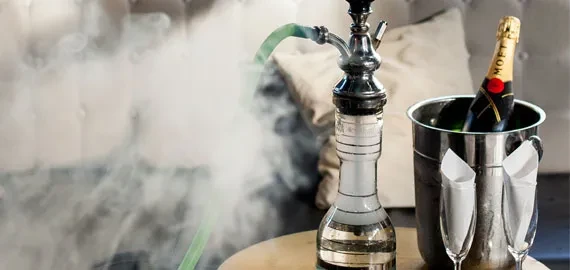 Lit glass hookah, chilled champagne bottle in ice, and flutes.