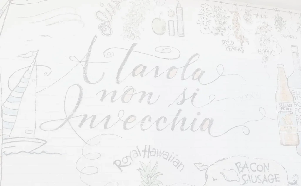 Mural: 'A Tavola non si Invecchia' surrounded by culinary elements.