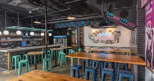 Modern industrial taproom with bar, beer taps, and "NEW IMAGE BREWING" logo.