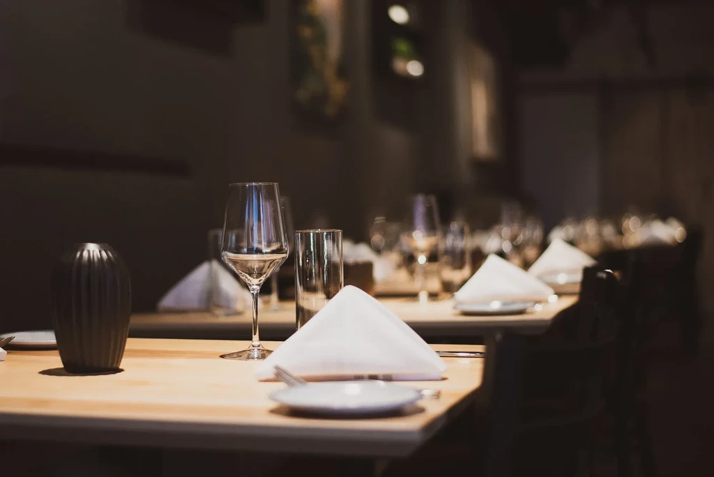 Elegant dining table setting in a dimly lit restaurant.