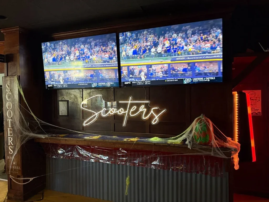 Scooters bar area featuring sports TVs and Halloween decorations.