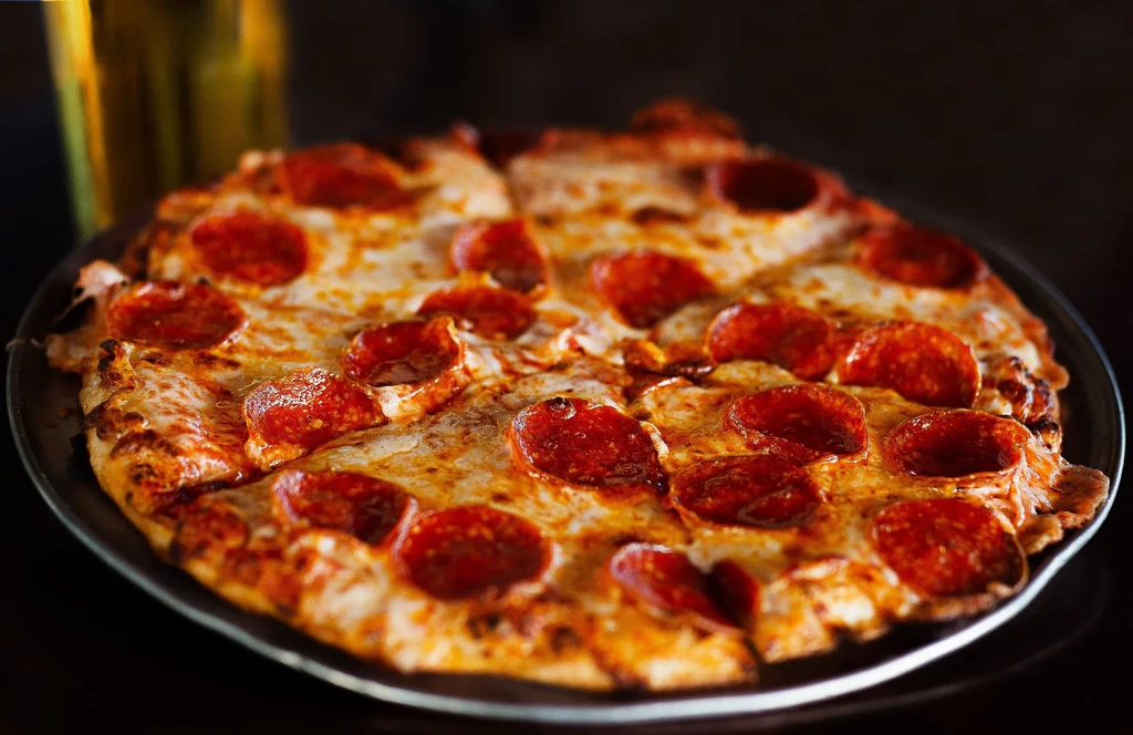 Freshly baked pepperoni pizza with bubbly cheese and curled crispy pepperoni.