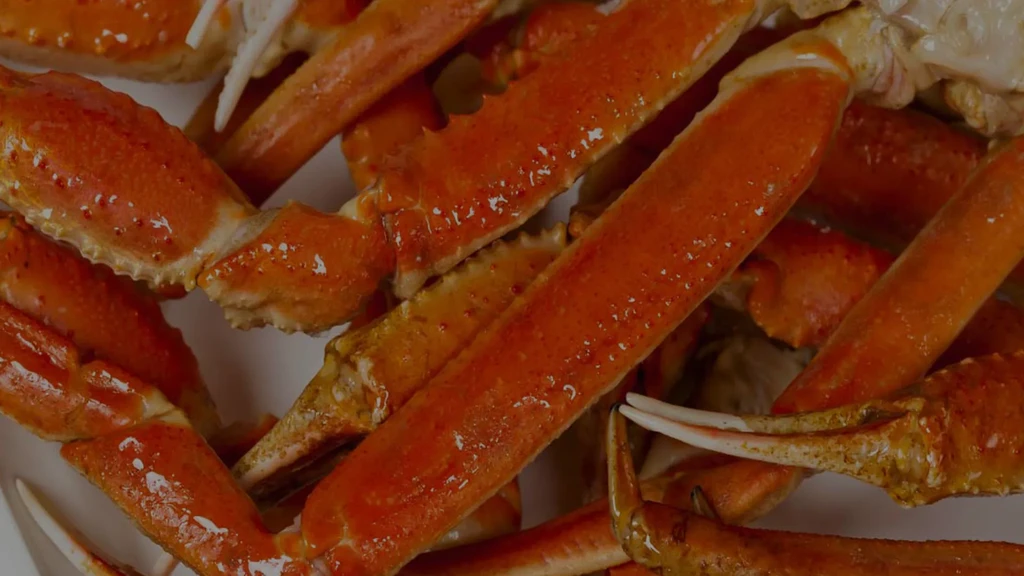Glistening, vibrant orange cooked crab legs piled generously.