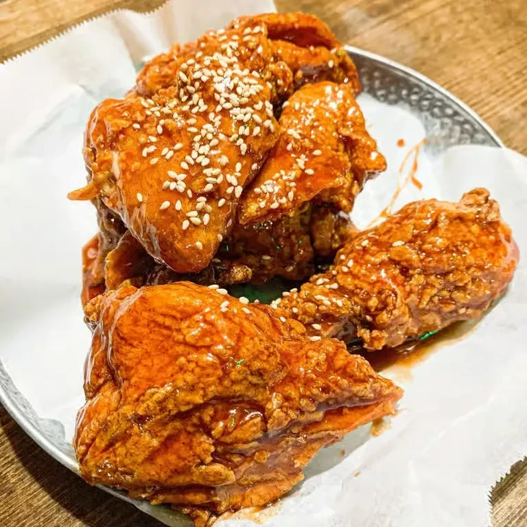 Korean fried chicken with sweet and spicy glaze and sesame seeds.
