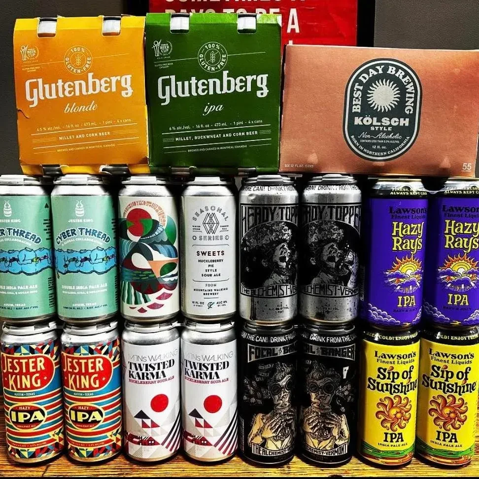 Rows and stacks of diverse craft beer cans and multi-packs.