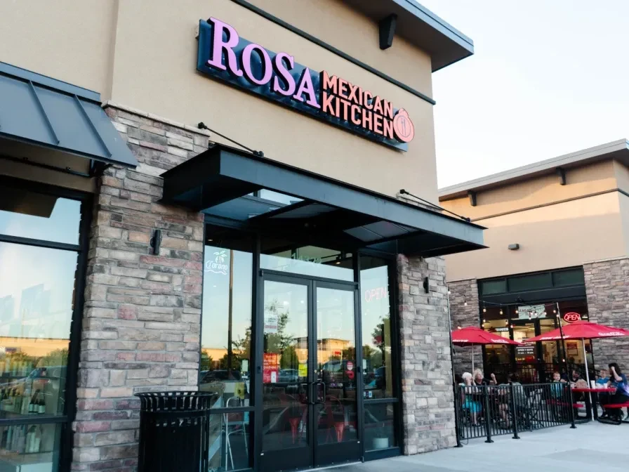 Rosa Mexican Kitchen exterior with people dining on an outdoor patio.
