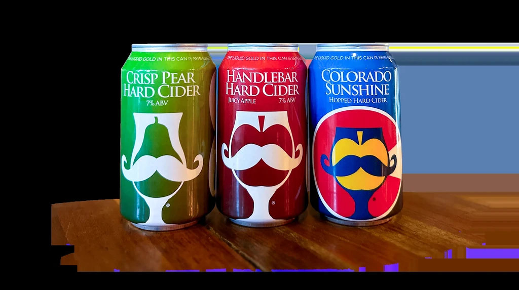 Green, red, blue hard cider cans with mustache logos on wood.