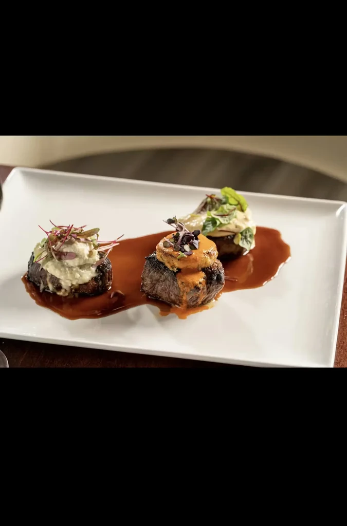 Gourmet meat portions with different garnishes and a rich dark sauce.