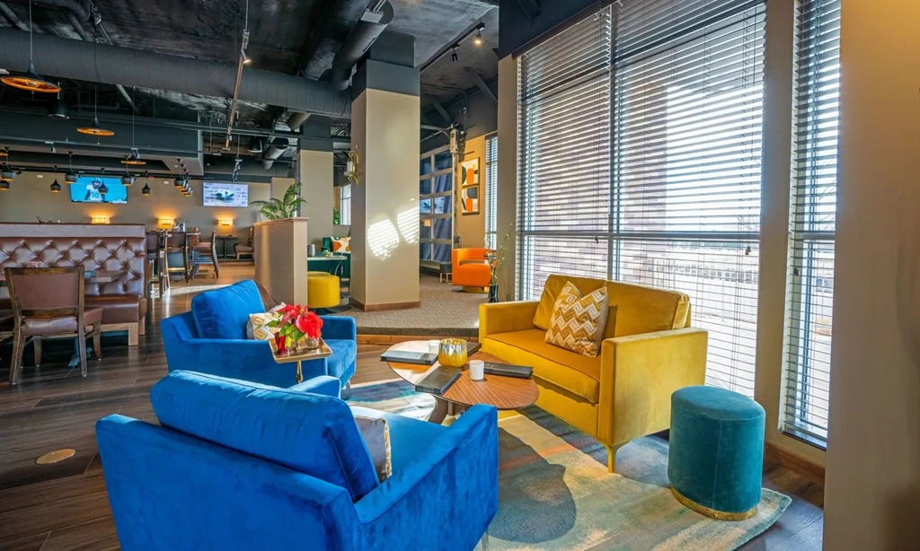Vibrant modern restaurant interior with velvet seating, leather booths, and sports TVs.