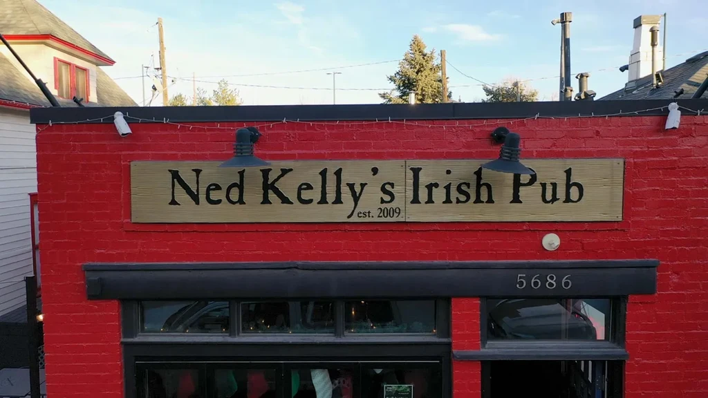 Ned Kelly's Irish Pub sign on red brick building.