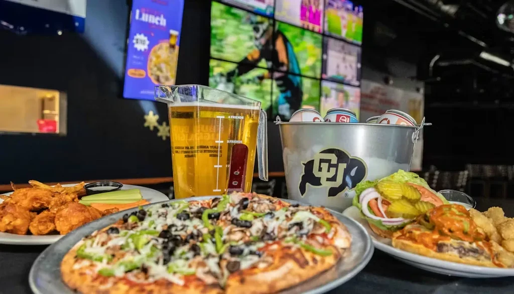 Food, beer, and sports on screens in a casual restaurant.
