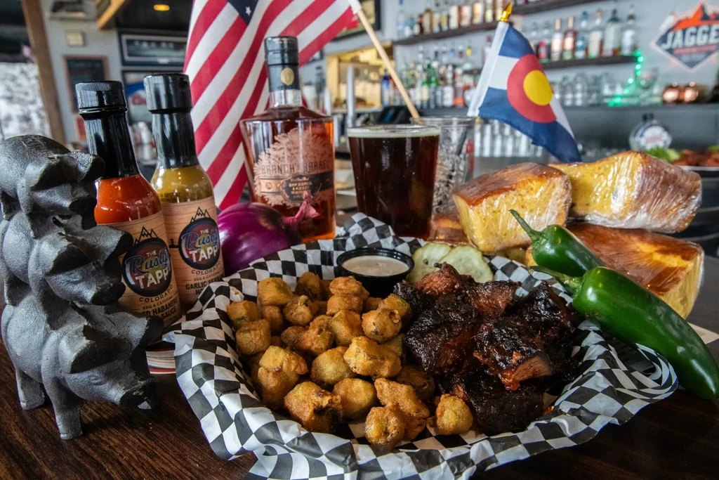Basket of fried okra, brisket, beer, whiskey, and hot sauce.
