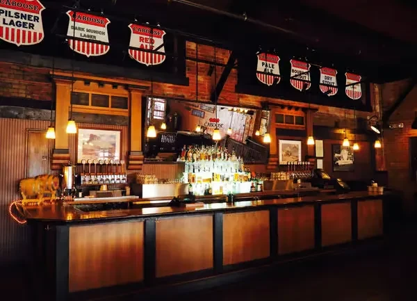 Interior bar view featuring Caboose beer signs, taps, and bottles.