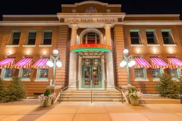 Historic Union Pacific building, now a chophouse and brewery, lit at night.