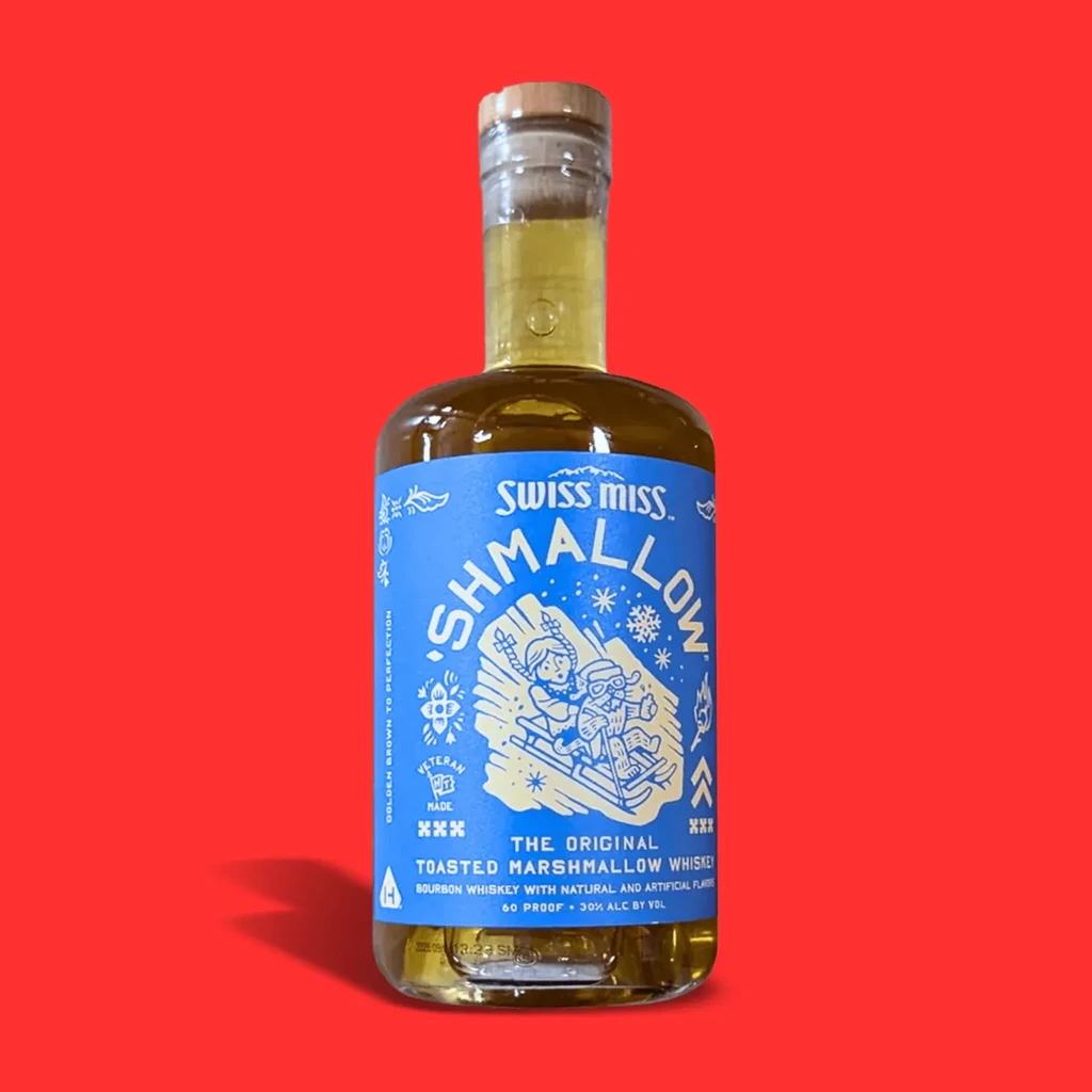 Bottle of Swiss Miss 'Shmallow' Toasted Marshmallow Whiskey on red background.