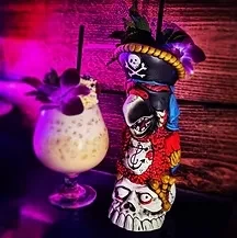 Detailed pirate tiki mug and creamy drink, vibrant purple-pink light.
