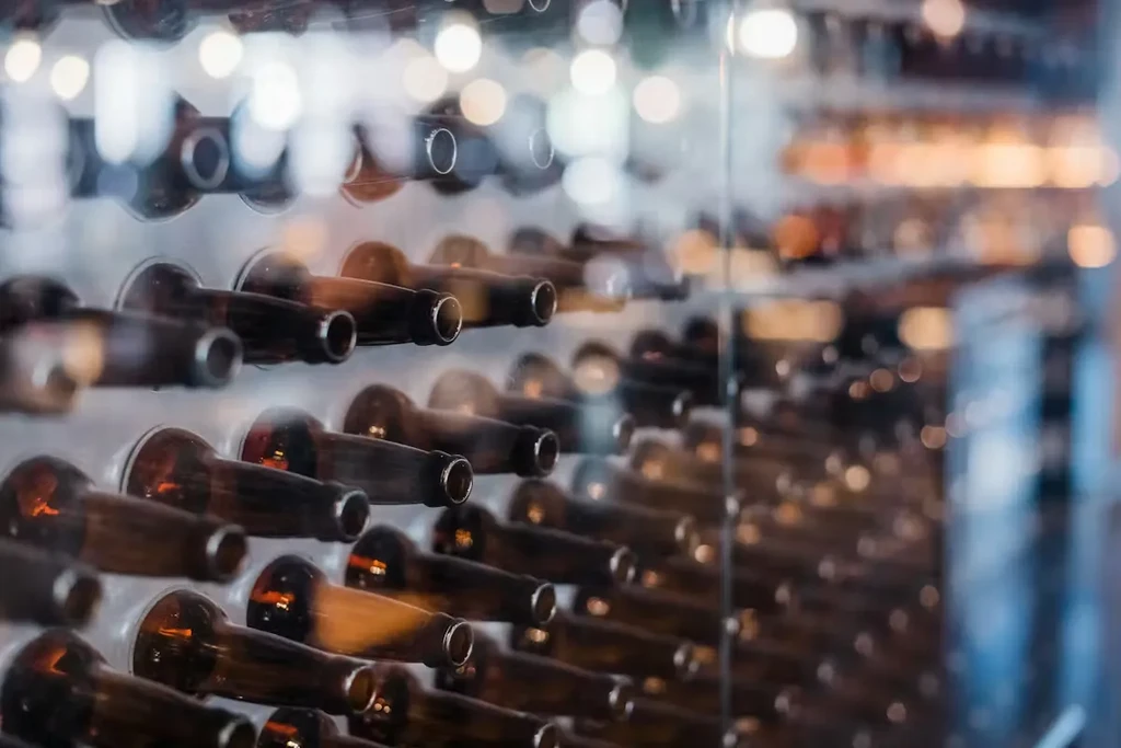 Close-up of amber glass bottles arranged in rows, blurred background.