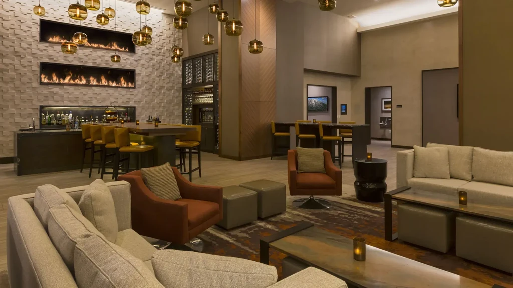 Sophisticated modern restaurant lounge with twin fireplaces and warm lighting.