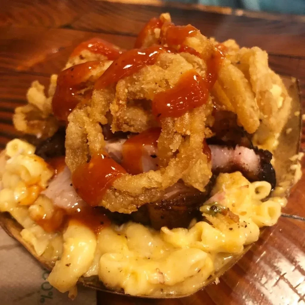 Layered mac and cheese, smoked meat, onion rings, drizzled with BBQ sauce.