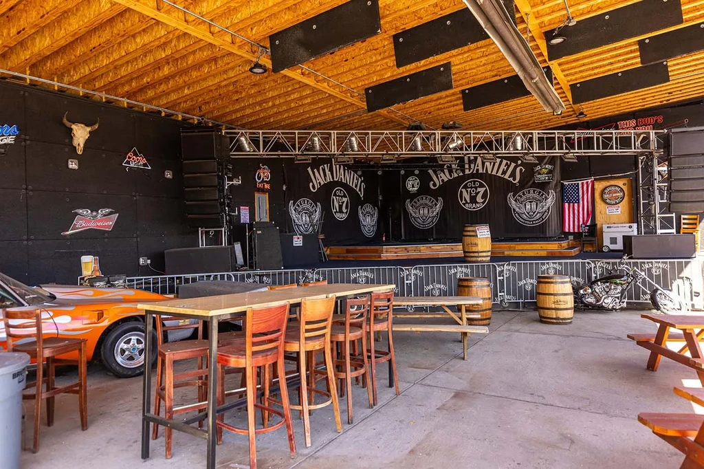 Bar interior with stage, Jack Daniel's banners, and biker decor.