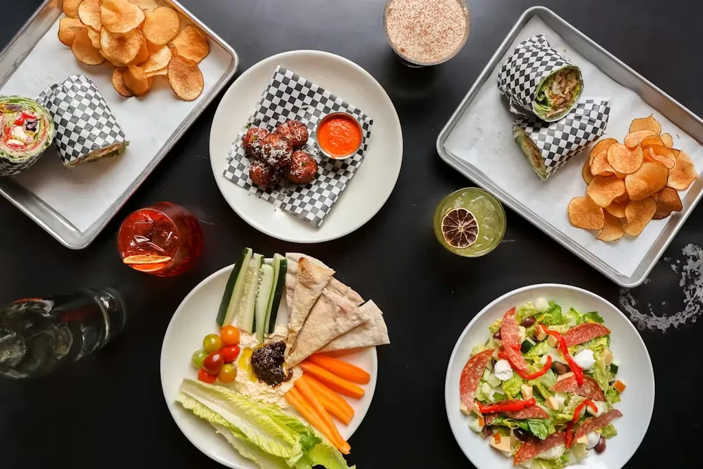 Overhead shot of a restaurant table filled with assorted dishes and drinks.