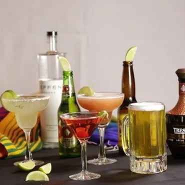 Mexican-themed cocktails and beers with lime and colorful serape.