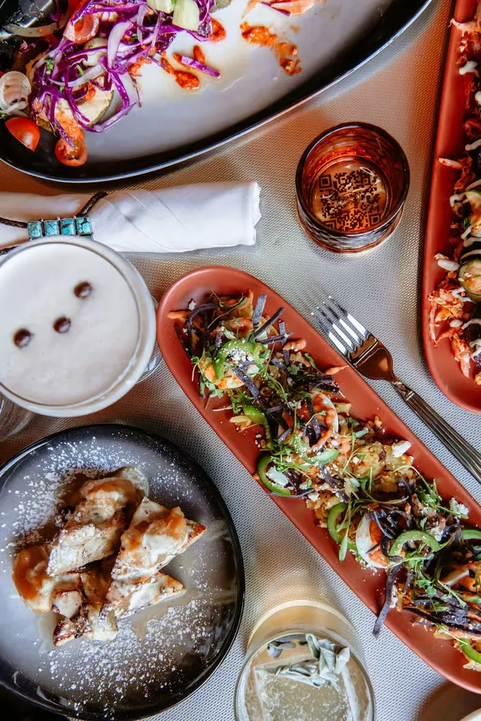 Overhead view: dining table with various food dishes and drinks.