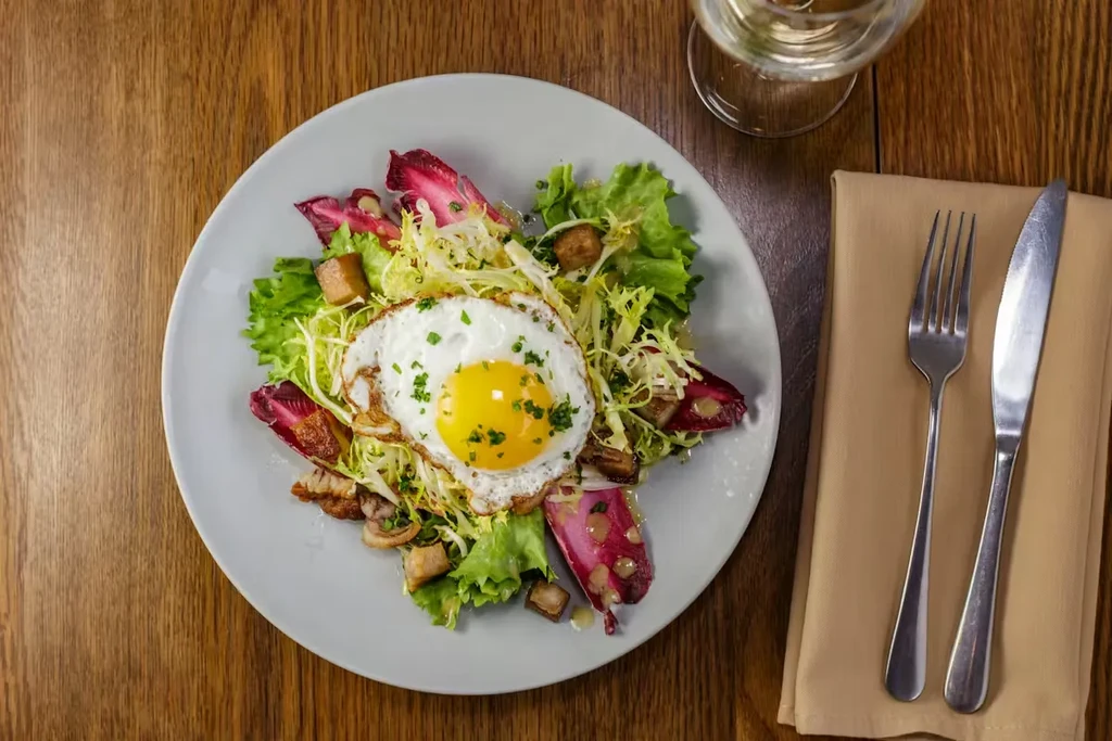 Gourmet salad with frisee, radicchio, and a fried egg.