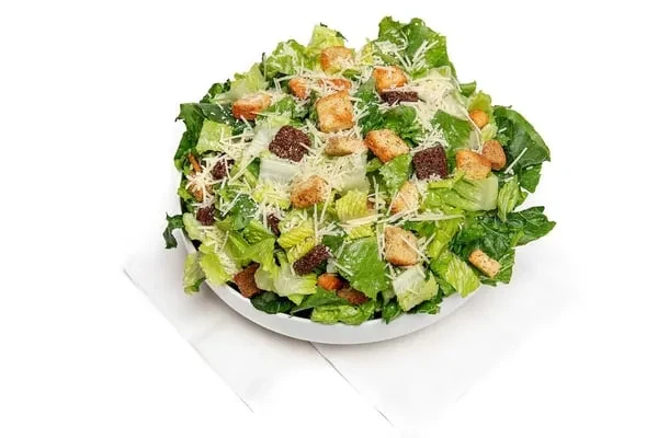 Vibrant Caesar salad with romaine, Parmesan, and varied croutons.