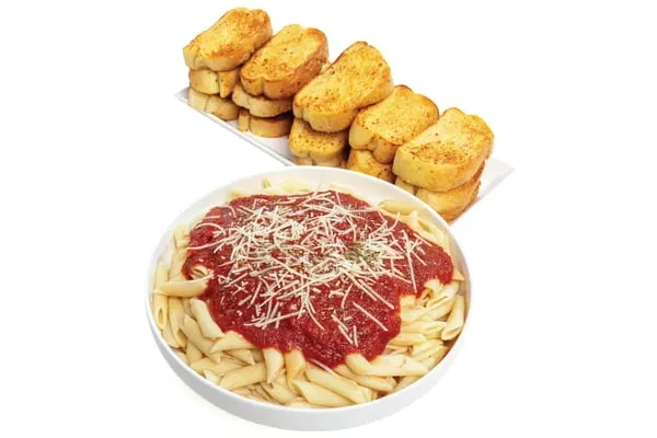Penne pasta with red sauce, grated cheese, garlic bread on white background.