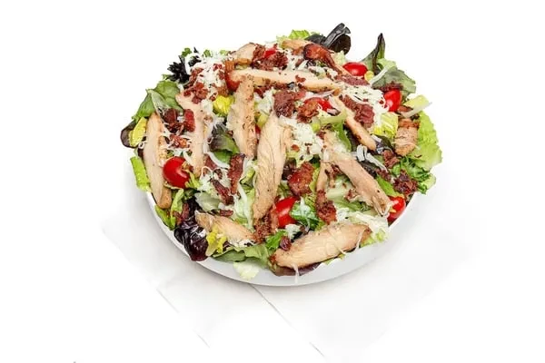Grilled chicken salad with bacon, cheese, tomatoes, and mixed greens.