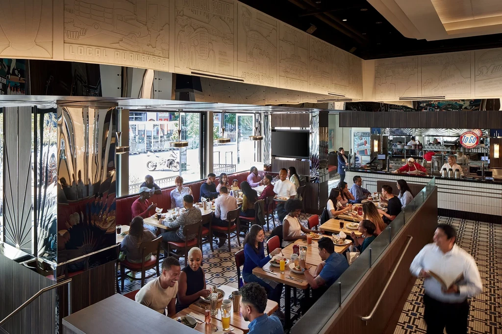 Lively modern restaurant interior with customers, staff, and local farm decor.