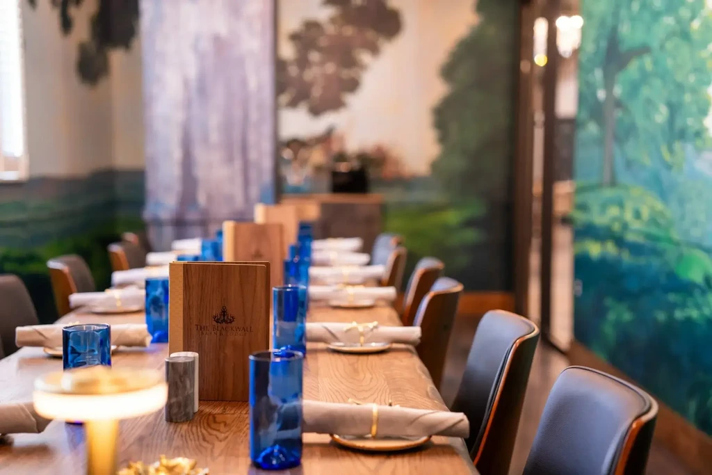 The Blackwall Bar & Lounge's long wooden dining table, meticulously set.