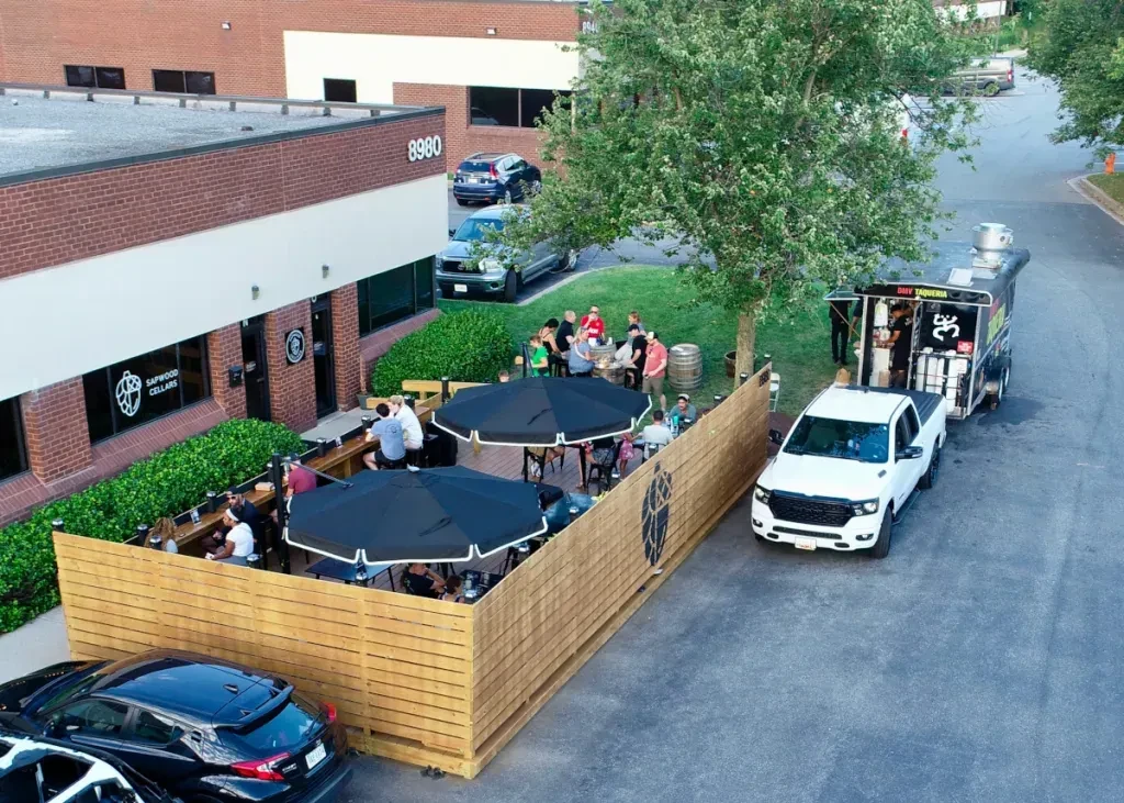 Lively outdoor patio dining at Sapwood Cellars winery with food truck.