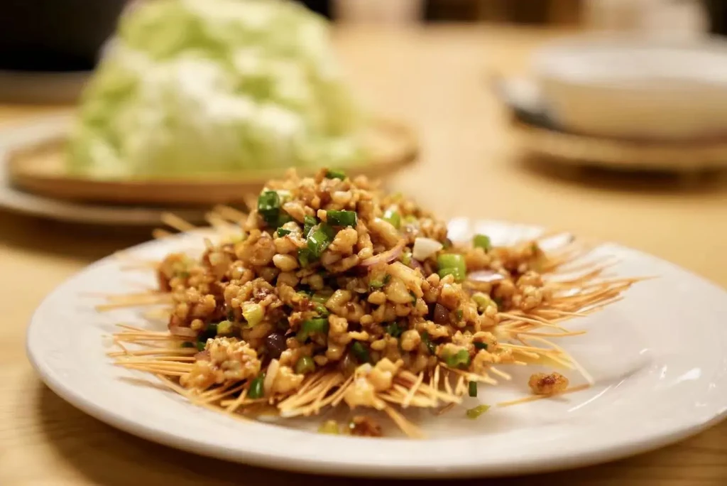 Finely chopped stir-fry on crispy noodles, with lettuce for wraps.