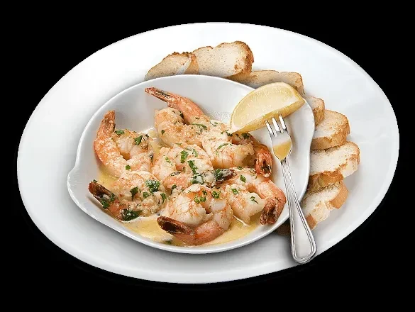 Garlic butter shrimp with herbs, lemon, and toasted baguette slices.