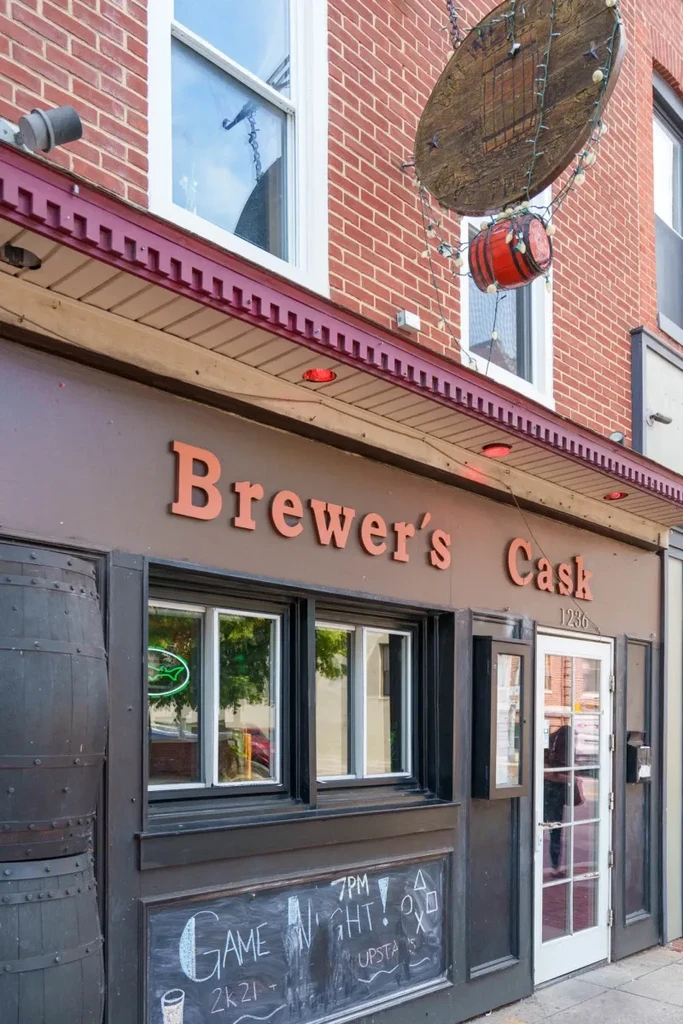 Brewer's Cask brick building exterior, prominent sign, chalkboard, and green neon.