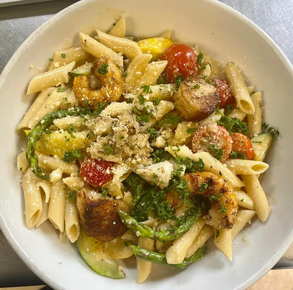 Creamy penne pasta with shrimp, scallops, vegetables, and Parmesan.