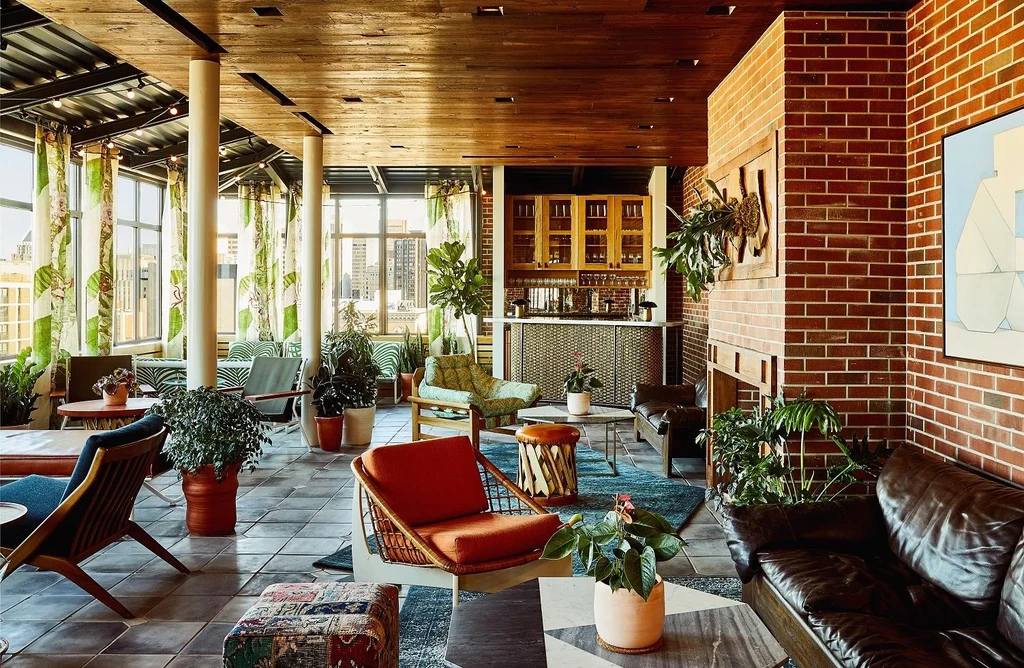 Modern rustic bar lounge with diverse seating and botanical decor.