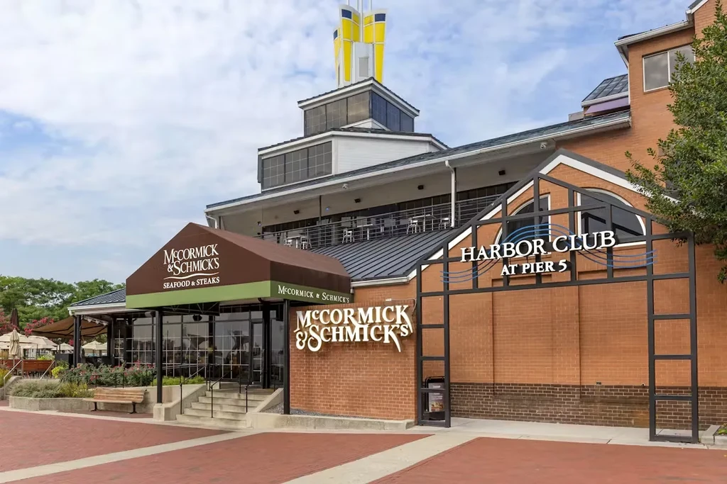 McCormick & Schmick's restaurant exterior, multi-story building, patio, and distinctive spire.