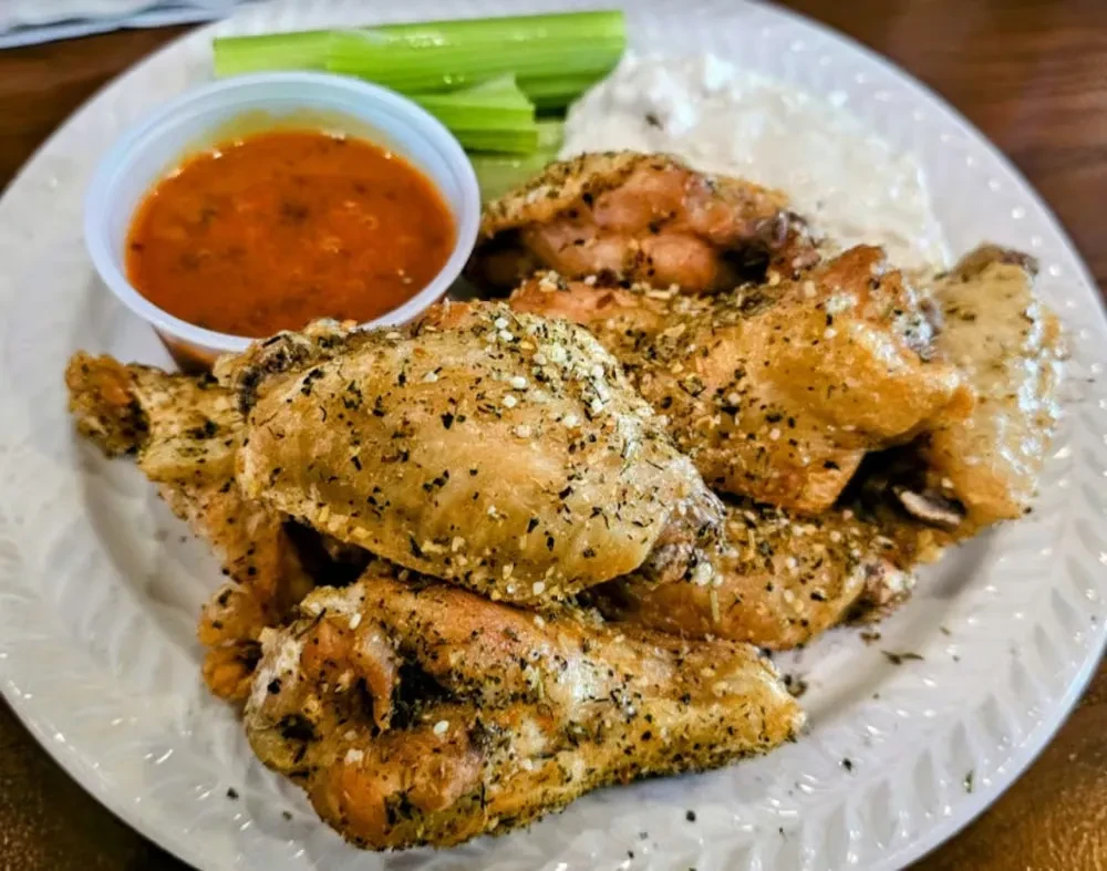 Seasoned chicken wings, orange dipping sauce, creamy white dressing, and celery.