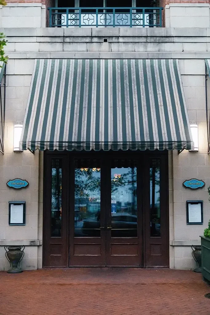 Cinchiale restaurant entrance with green and white striped awning.