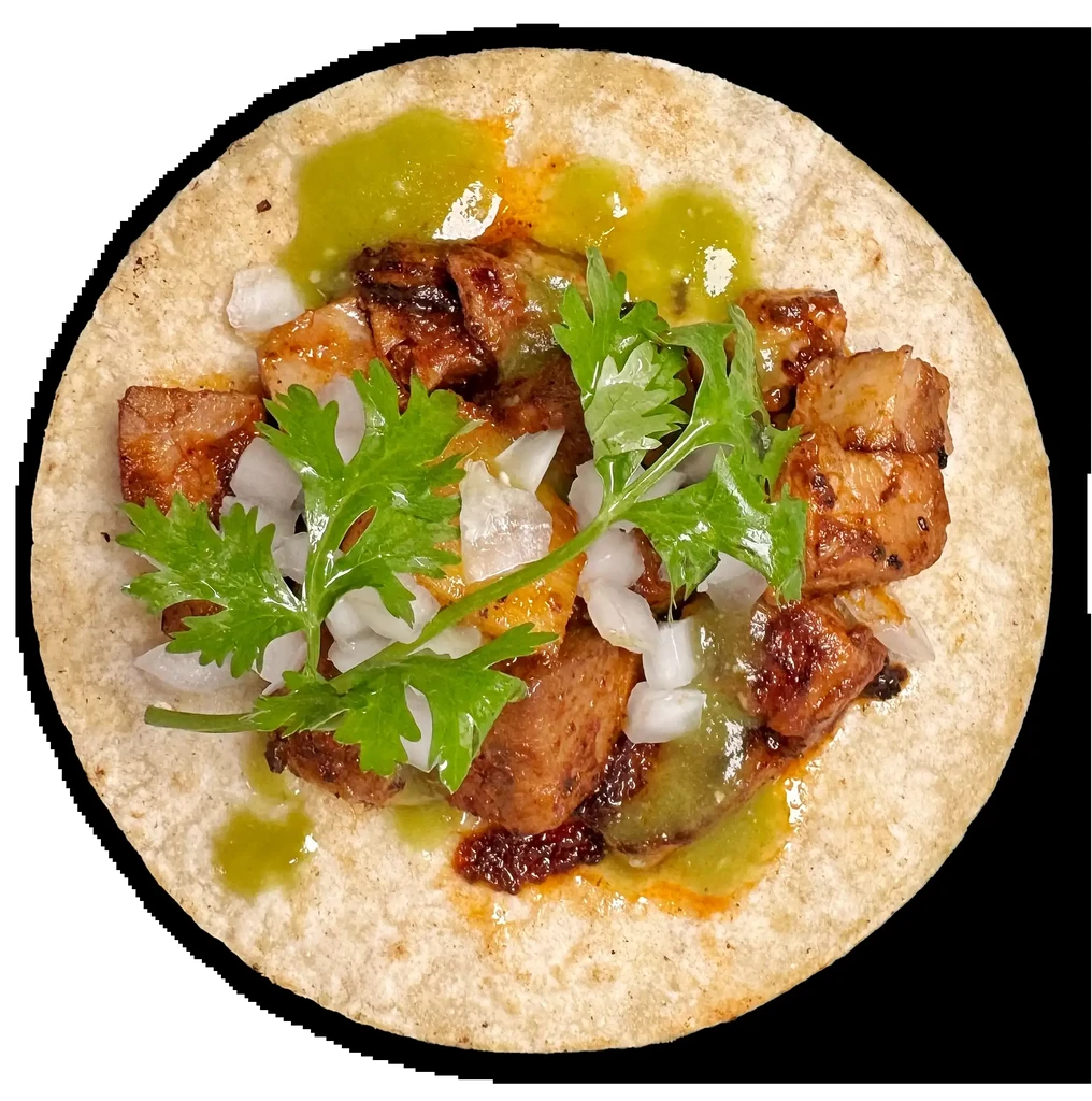 Overhead close-up: taco with seared meat, onion, cilantro, two sauces.