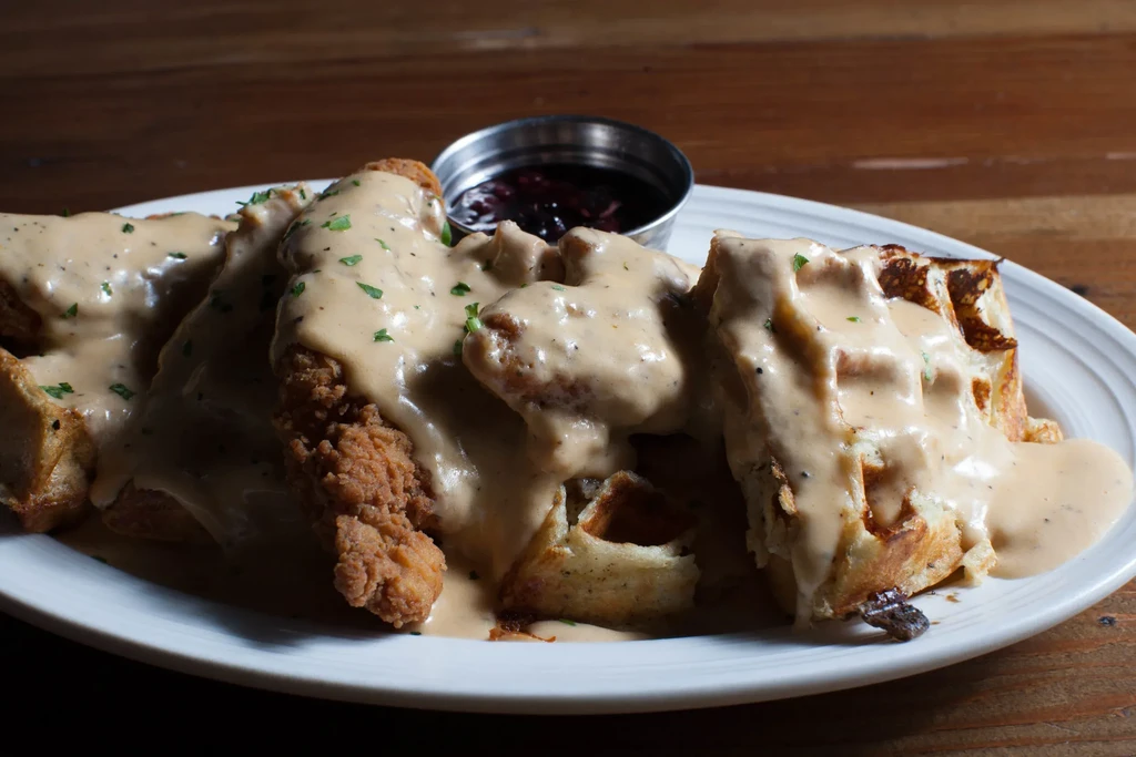 Crispy chicken and waffles smothered in gravy with berry compote.