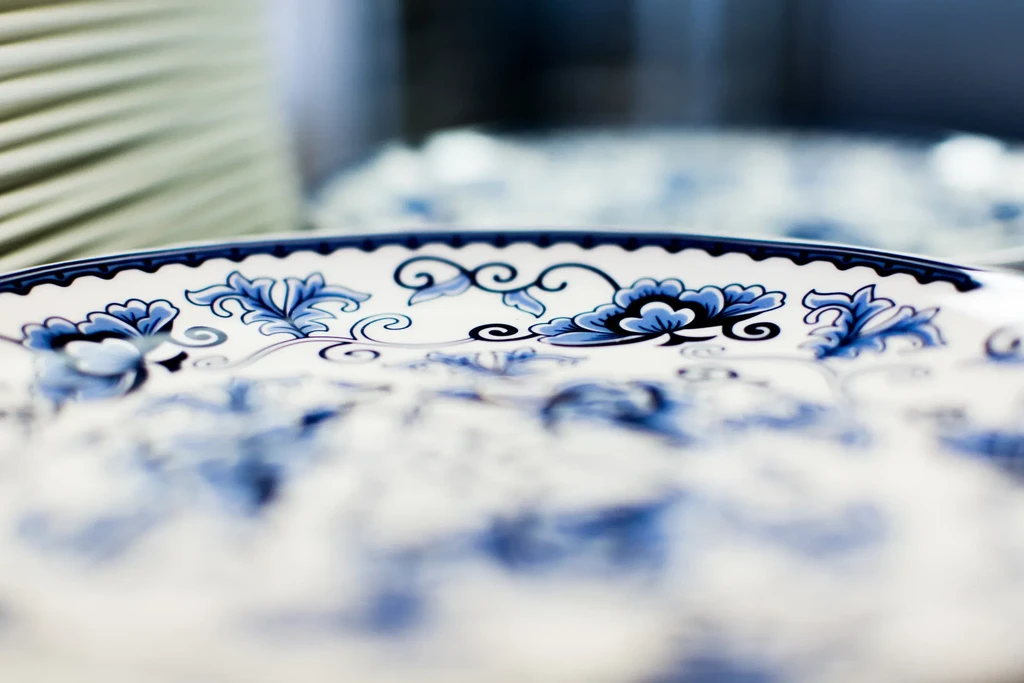White ceramic plate with intricate blue floral patterns, blurred background.