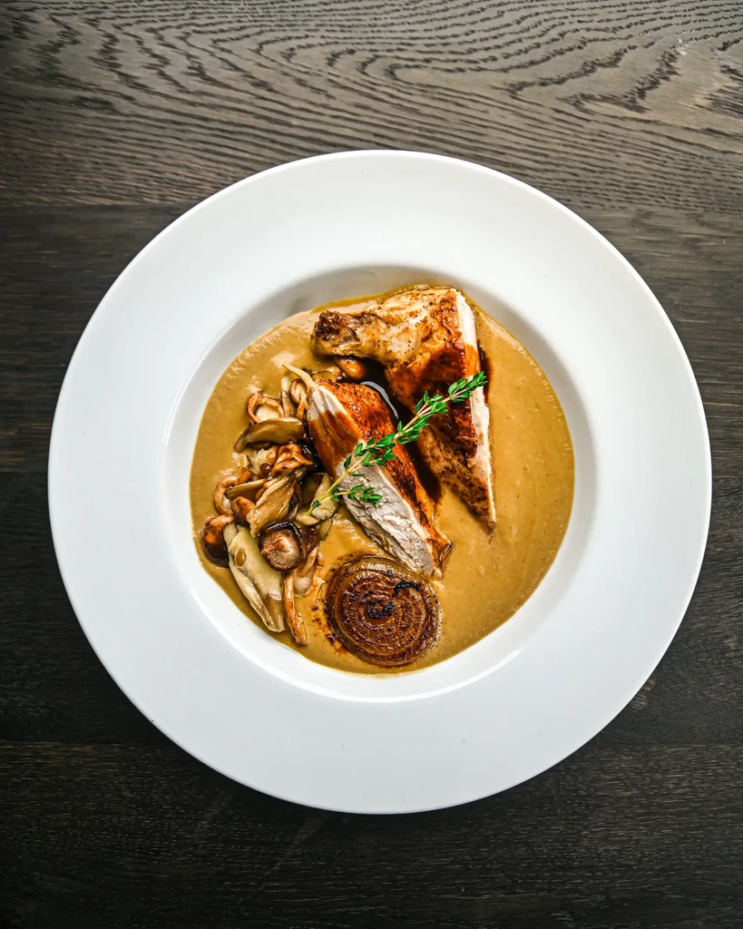 Roasted chicken with mushrooms, onion, and herbs in a creamy sauce.