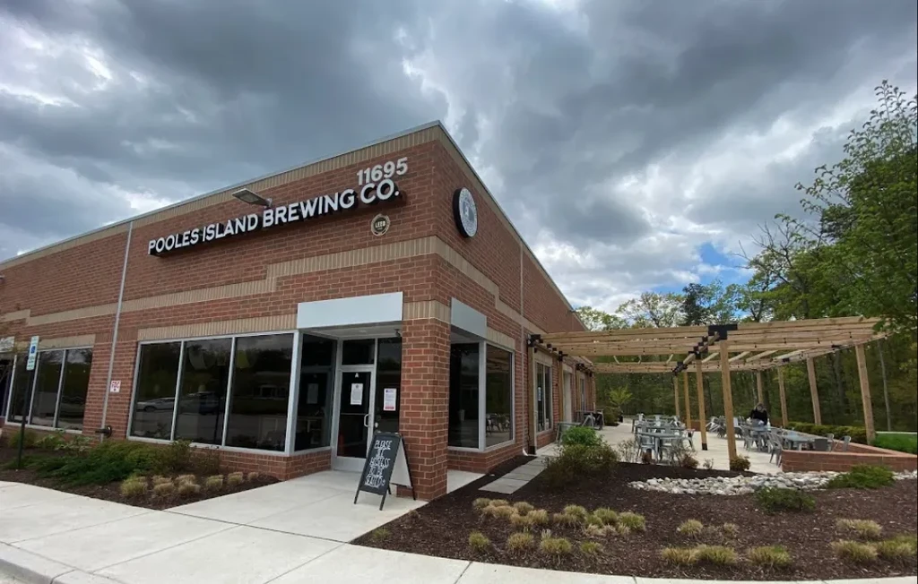 Poole's Island Brewing Co. brick building and outdoor patio with pergola.