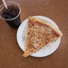 Single cheese pizza slice on a paper plate with a soda.